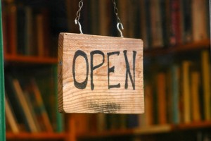 Retail and shopping image of an open sign in a book store window