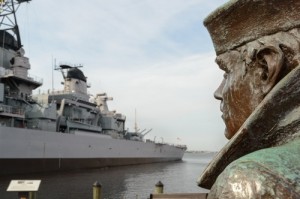 Norfolk, va - October 29: The Lone Sailor statue in Norfolk looks upon the USS Wisconson BB64. This bronze statue created by Stanley Bleifeld is one of twelve statues that are placed in different locations in the U.S.